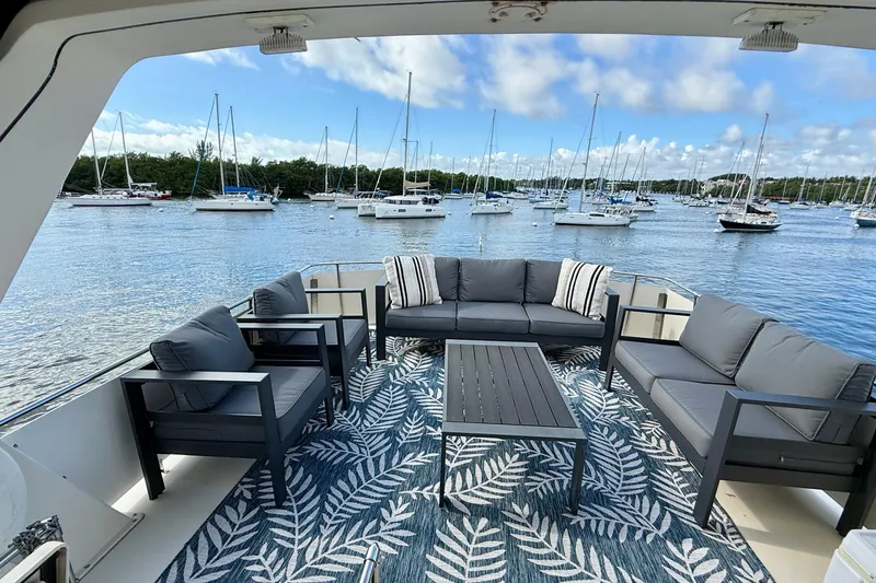 Slide: The Image of Luxurious 1987 Chris-Craft 500 Constellation yacht deck with elegant seating and scenic marina view. - 21