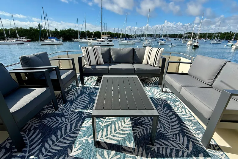 Slide: The Image of Outdoor seating on 1987 Chris-Craft 500 Constellation yacht, overlooking marina with sailboats. - 23