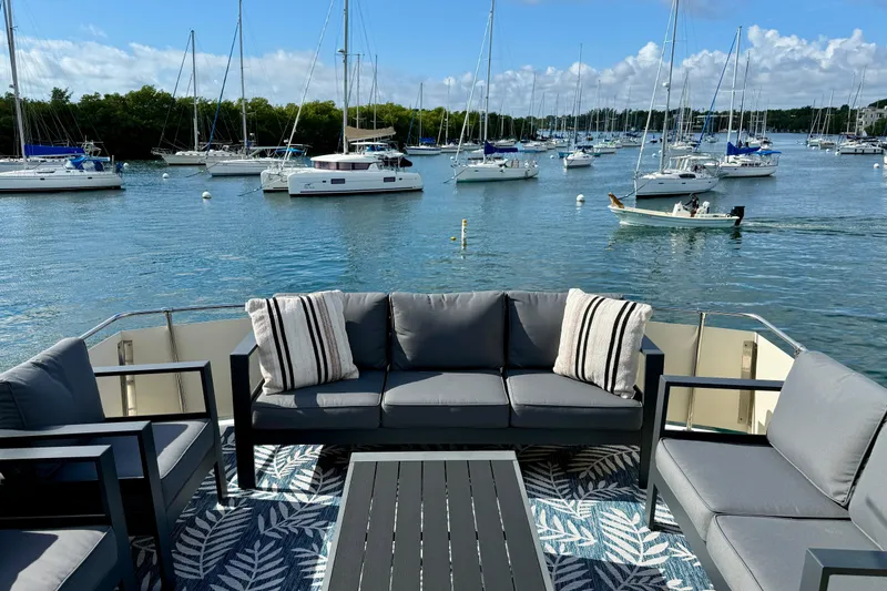 Slide: The Image of Luxurious 1987 Chris-Craft 500 Constellation yacht deck with elegant seating, overlooking serene marina. - 26