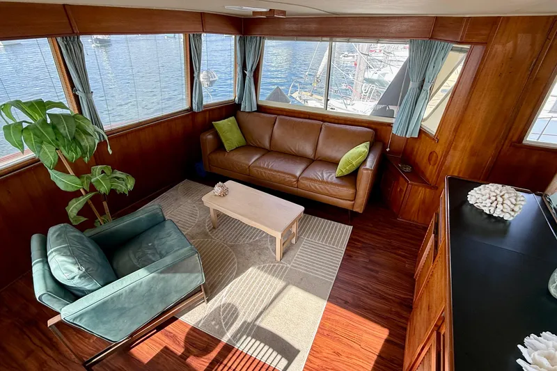 Slide: The Image of Luxurious 1987 Chris-Craft 500 Constellation yacht interior with leather sofa and scenic windows. - 28
