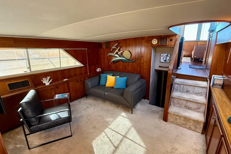 Slide: The Image of Luxurious 1987 Chris-Craft 500 Constellation yacht interior with modern seating and elegant wood paneling. - 3