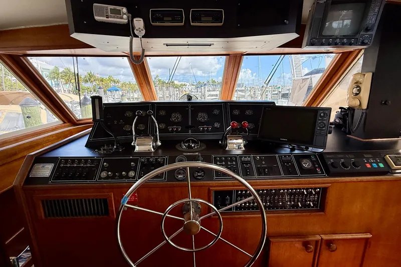 Slide: The Image of 1987 Chris-Craft 500 Constellation yacht helm with steering wheel and navigation equipment. - 33