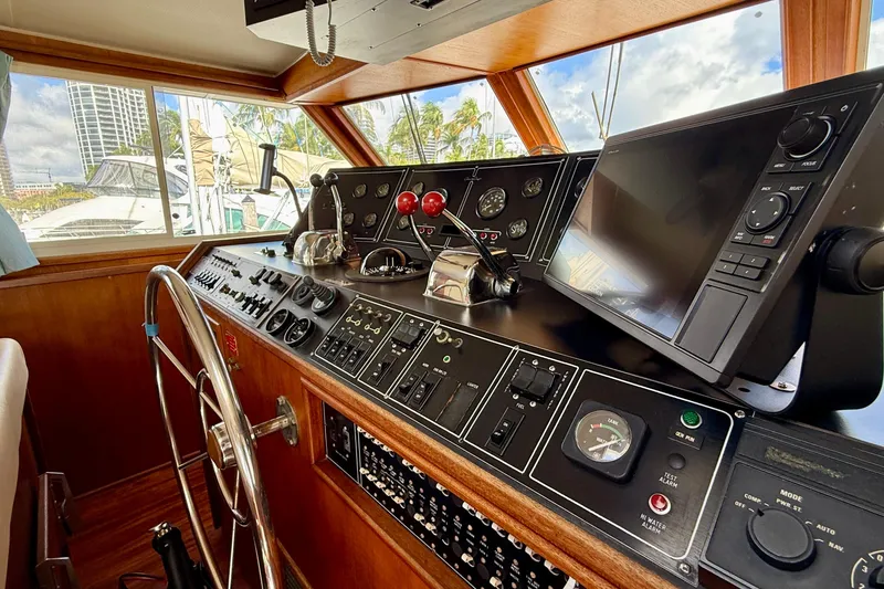 Slide: The Image of 1987 Chris-Craft 500 Constellation helm with navigation controls and steering wheel. - 35