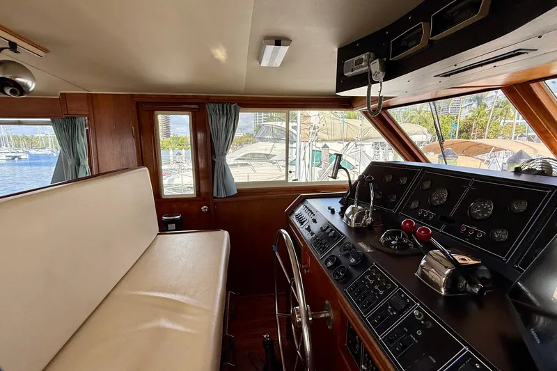 Slide: The Image of Interior helm of 1987 Chris-Craft 500 Constellation yacht with control panel and seating. - 38