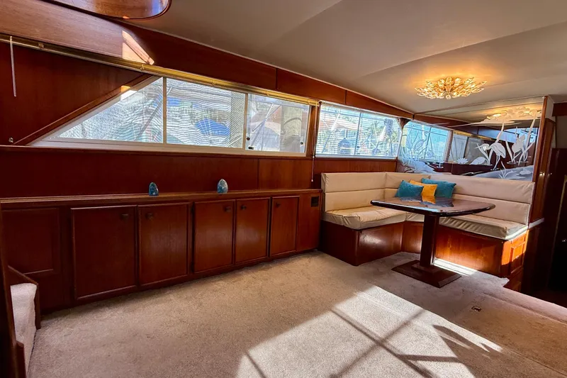 Slide: The Image of Luxurious 1987 Chris-Craft 500 Constellation yacht interior with elegant wood paneling and cozy seating. - 4
