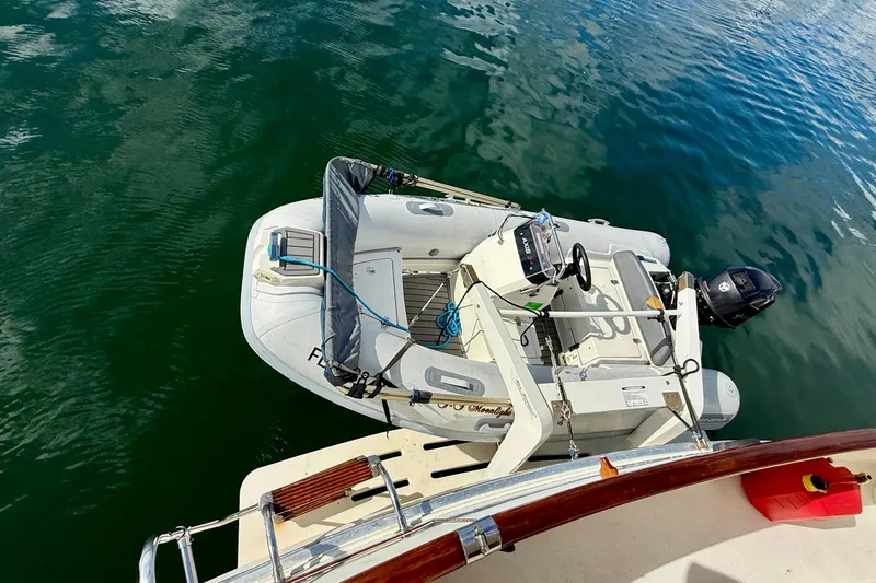 Slide: The Image of 1987 Chris-Craft 500 Constellation yacht with attached inflatable dinghy on calm water. - 40