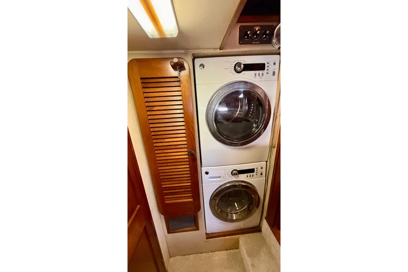 Slide: The Image of Laundry area with stacked washer and dryer in 1987 Chris-Craft 500 Constellation yacht. - 43