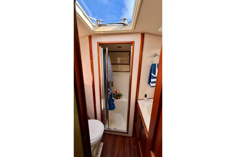 Slide: The Image of 1987 Chris-Craft 500 Constellation yacht bathroom with skylight, shower, and wooden accents. - 46