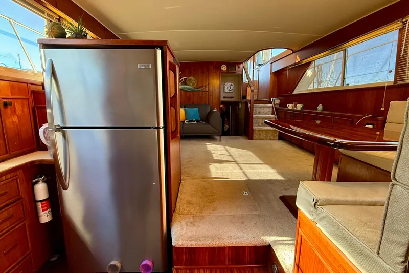 Slide: The Image of 1987 Chris-Craft 500 Constellation yacht interior with kitchen and seating area. - 9