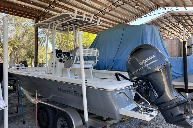 The Image of 2021 NauticStar 227 XTS boat with Yamaha engine in covered storage. - 0