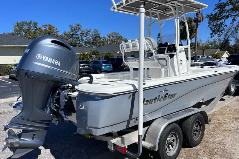Slide: The Image of 2021 NauticStar 227 XTS boat with Yamaha engine on trailer in parking lot. - 12
