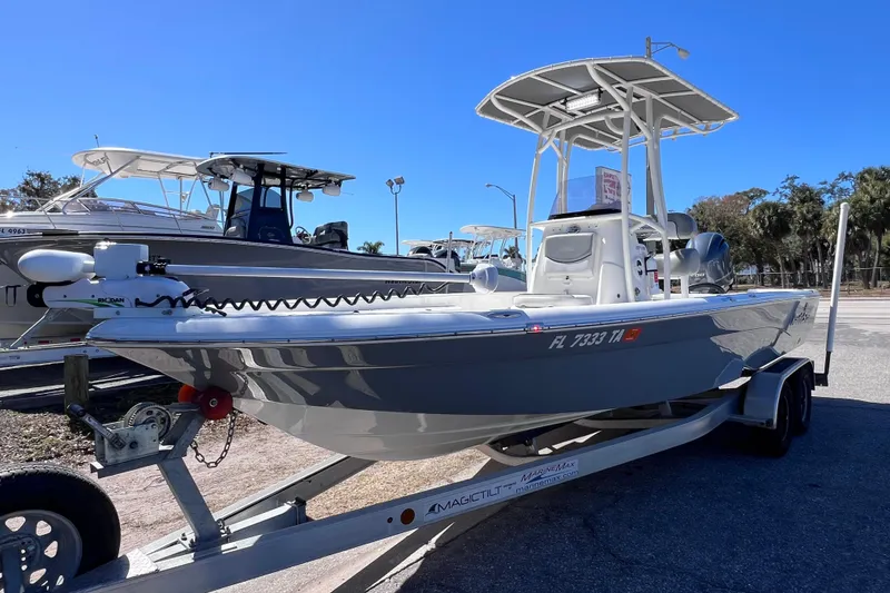 Slide: The Image of 2021 NauticStar 227 XTS boat on trailer, sunny day, marina background. - 16