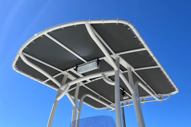 Slide: The Image of T-top of 2021 NauticStar 227 XTS boat against clear blue sky. - 17