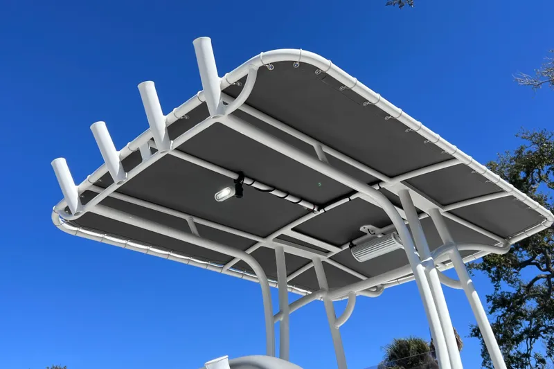 Slide: The Image of T-top of 2021 NauticStar 227 XTS boat against clear blue sky. - 18