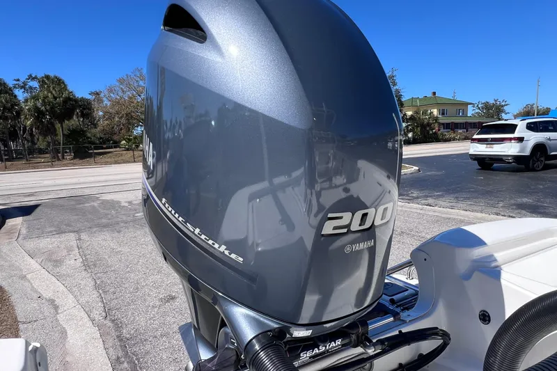 Slide: The Image of 2021 NauticStar 227 XTS with Yamaha 200 four-stroke engine in a parking lot. - 20