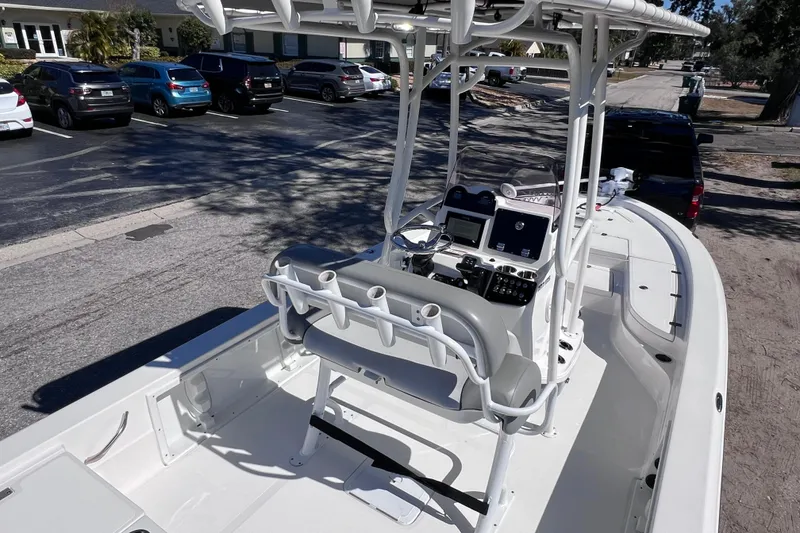 Slide: The Image of 2021 NauticStar 227 XTS boat with center console and seating, parked in a lot. - 21