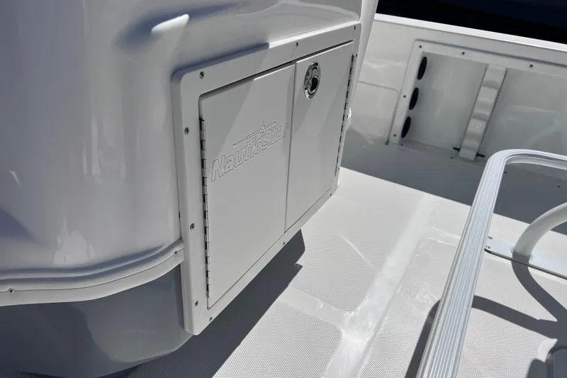 Slide: The Image of 2021 NauticStar 227 XTS boat interior with storage compartment and sleek design. - 40
