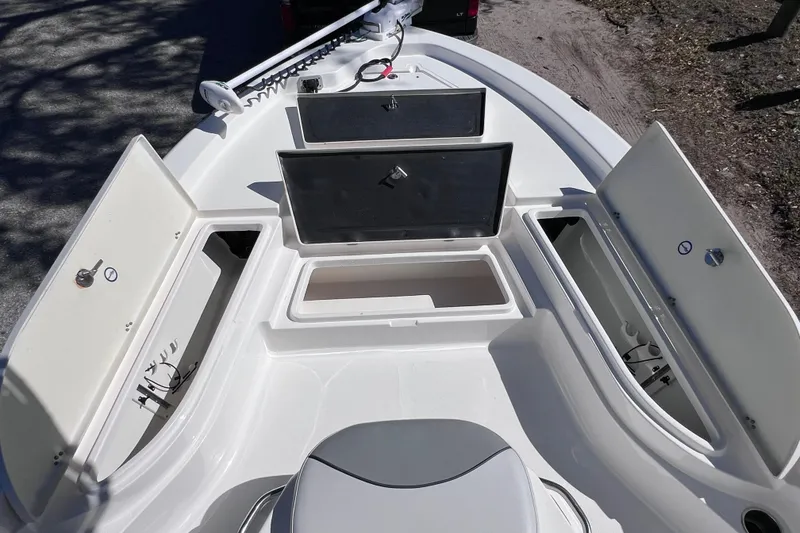 Slide: The Image of 2021 NauticStar 227 XTS boat with open storage compartments and seating area. - 45