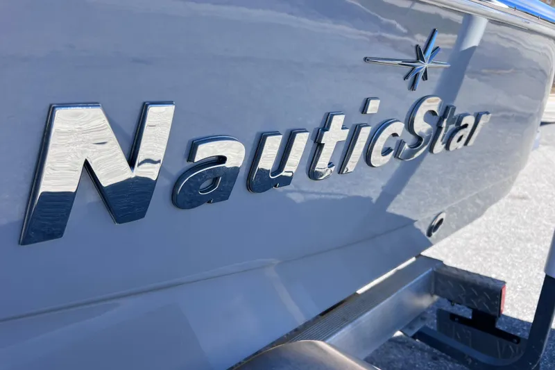 Slide: The Image of 2021 NauticStar 227 XTS boat logo on hull, close-up view. - 5