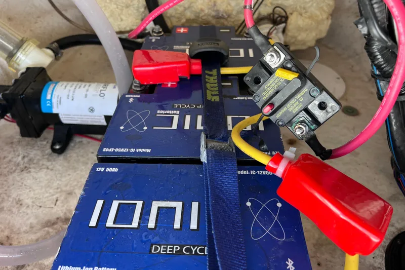 Slide: The Image of 2021 NauticStar 227 XTS boat battery setup with wiring and circuit breaker. - 56