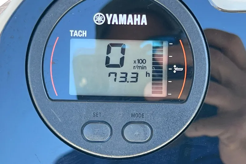 Slide: The Image of Yamaha tachometer displaying 73.3 hours on a 2021 NauticStar 227 XTS boat. - 58