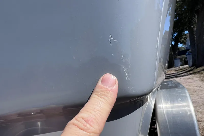 Slide: The Image of 2021 NauticStar 227 XTS boat with visible hull scratches. - 61