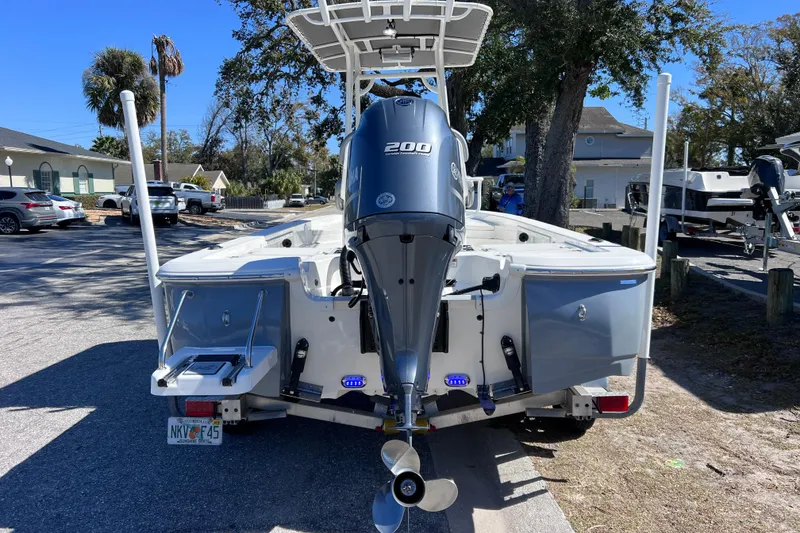 Slide: The Image of 2021 NauticStar 227 XTS boat with Yamaha 200 engine, parked on a trailer. - 7
