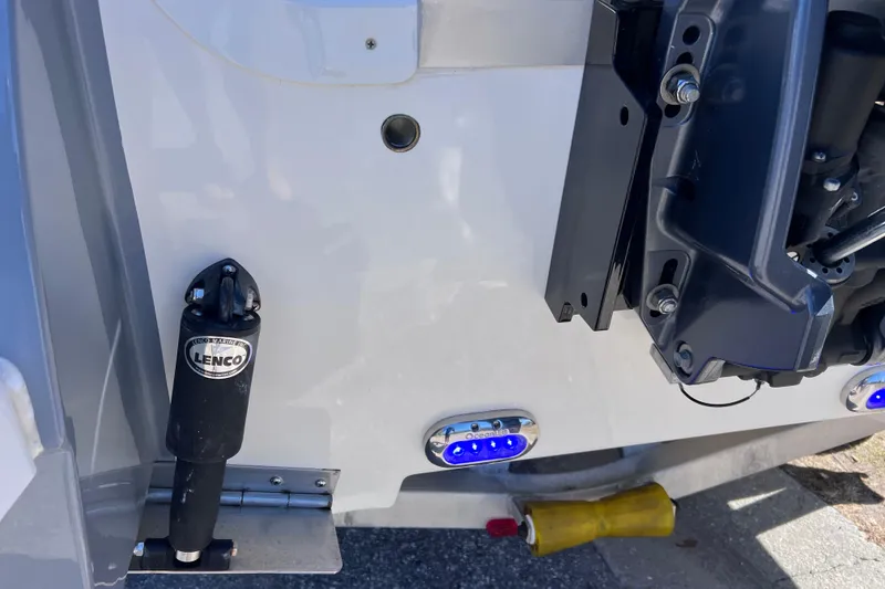 Slide: The Image of 2021 NauticStar 227 XTS boat with Lenco trim tab and blue LED lights. - 9