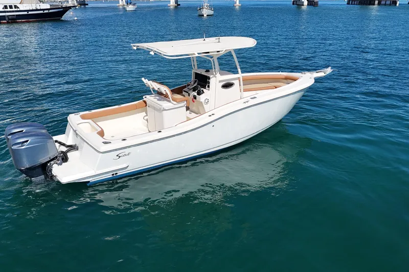 Slide: The Image of 2004 Scout 280 Sportfish boat on clear blue water, featuring twin engines. - 10