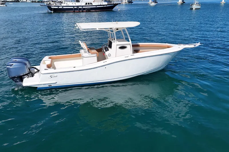 Slide: The Image of 2004 Scout 280 Sportfish boat on calm blue water, side view. - 11