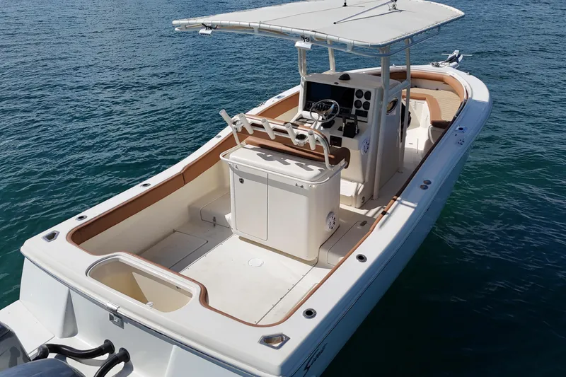 Slide: The Image of 2004 Scout 280 Sportfish boat on water, featuring spacious deck and modern console. - 14