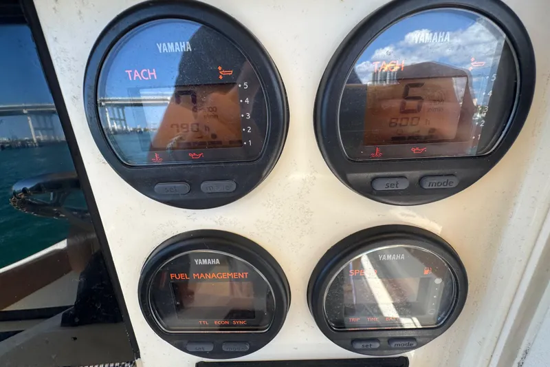 Slide: The Image of Yamaha gauges on 2004 Scout 280 Sportfish boat dashboard, displaying tachometer and fuel management. - 24