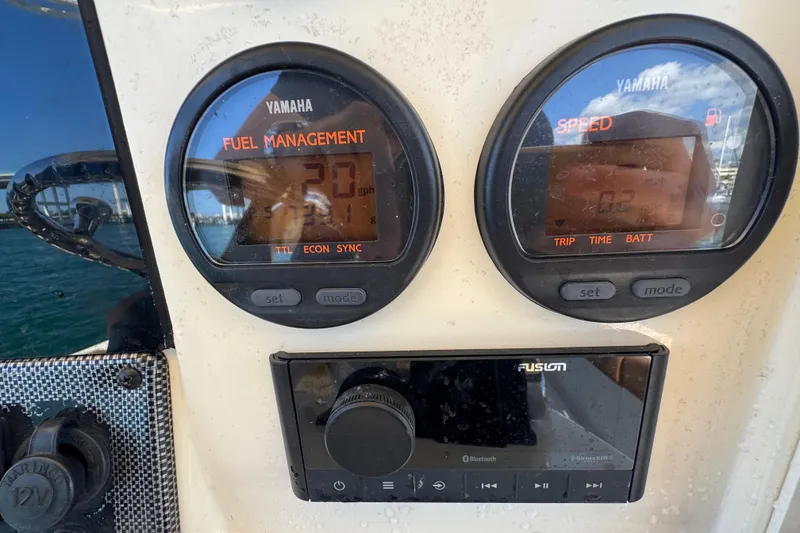 Slide: The Image of Yamaha fuel management and speed gauges on 2004 Scout 280 Sportfish boat dashboard. - 25
