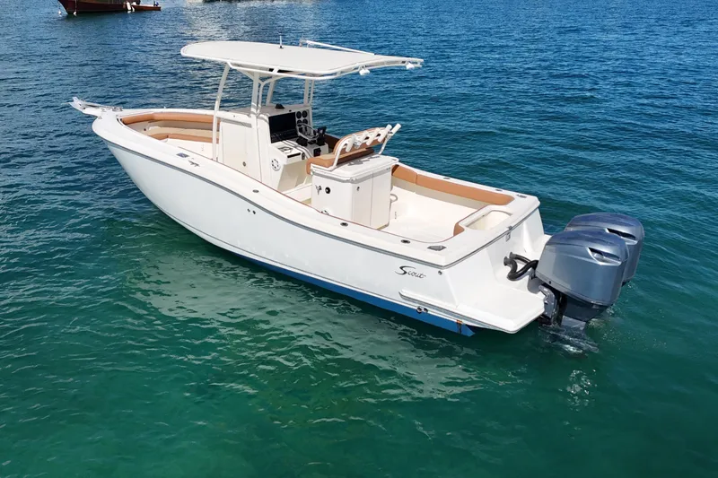 Slide: The Image of 2004 Scout 280 Sportfish boat with dual engines on clear blue water. - 3