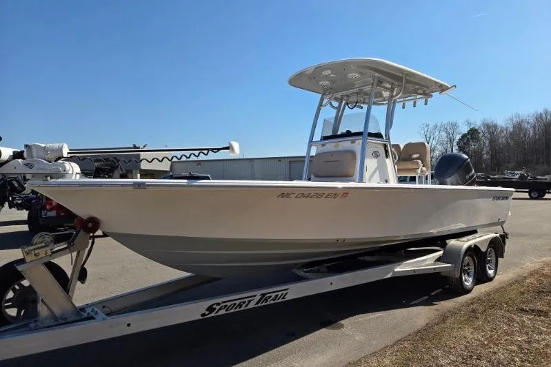 Slide: The Image of 2019 Sportsman Masters 247 Bay Boat on trailer, parked outdoors under clear sky. - 7