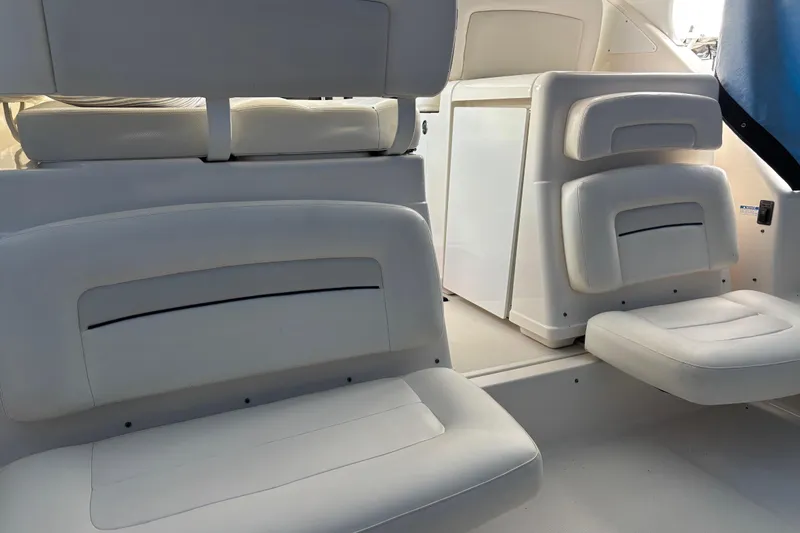Slide: The Image of Interior seating of 2005 Tiara Yachts 3600 Open, featuring white cushioned seats. - 10
