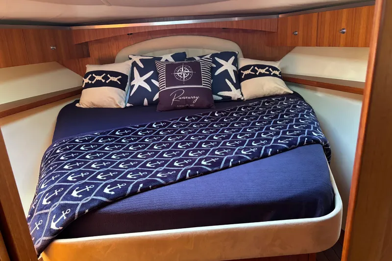 Slide: The Image of Luxurious cabin interior of 2005 Tiara Yachts 3600 Open with nautical-themed bedding. - 12