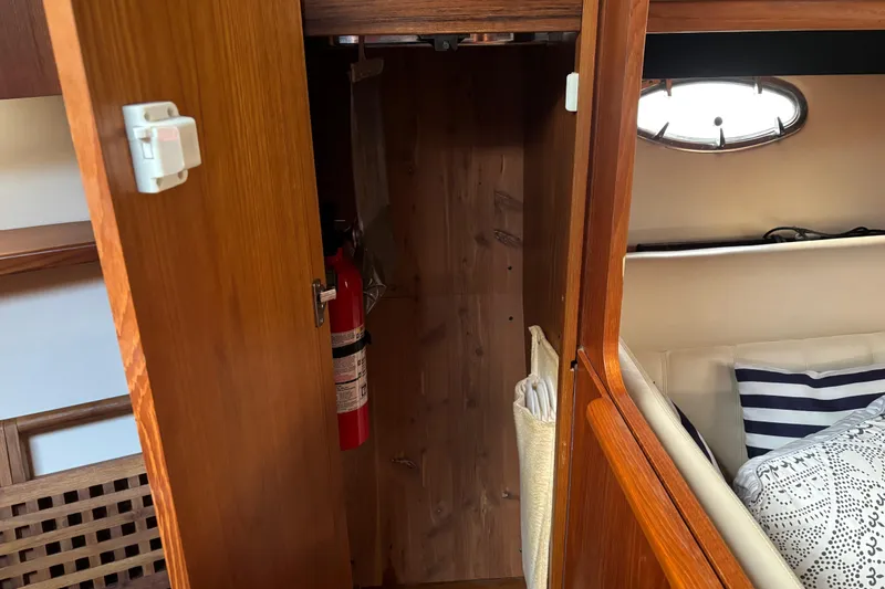 Slide: The Image of Interior of 2005 Tiara Yachts 3600 Open with wooden cabinetry and fire extinguisher. - 15