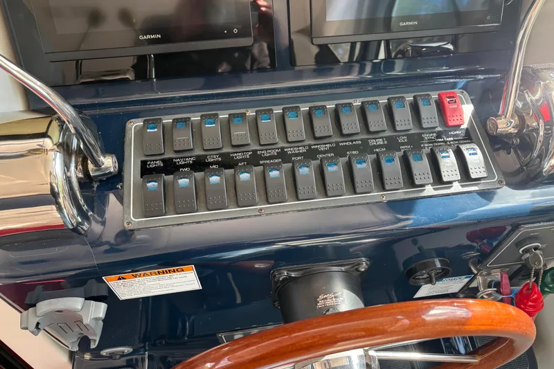 Slide: The Image of Control panel of a 2005 Tiara Yachts 3600 Open with switches and Garmin displays. - 21
