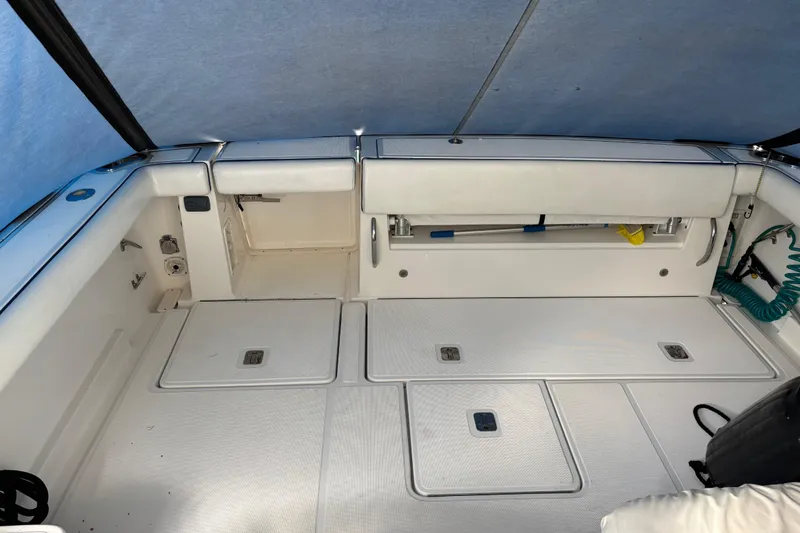 Slide: The Image of 2005 Tiara Yachts 3600 Open cockpit with storage compartments and clean white finish. - 24