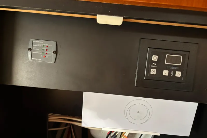 Slide: The Image of Control panel of a 2005 Tiara Yachts 3600 Open, featuring ProMariner and Dometic systems. - 28