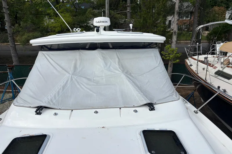 Slide: The Image of 2005 Tiara Yachts 3600 Open with covered windshield and Garmin equipment, docked outdoors. - 32