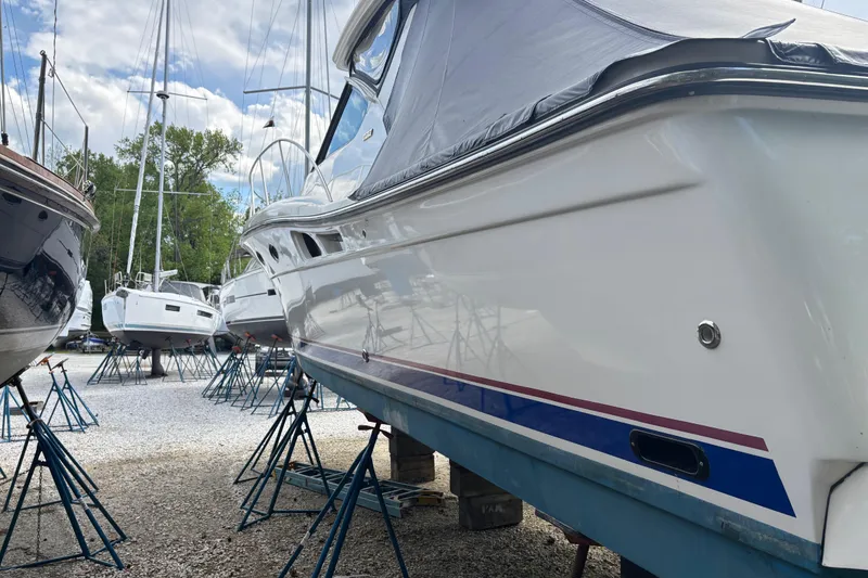 Slide: The Image of 2005 Tiara Yachts 3600 Open on stands, surrounded by other boats, under a cloudy sky. - 36