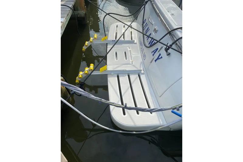 Slide: The Image of 2005 Tiara Yachts 3600 Open docked, featuring swim platform and mooring lines. - 5