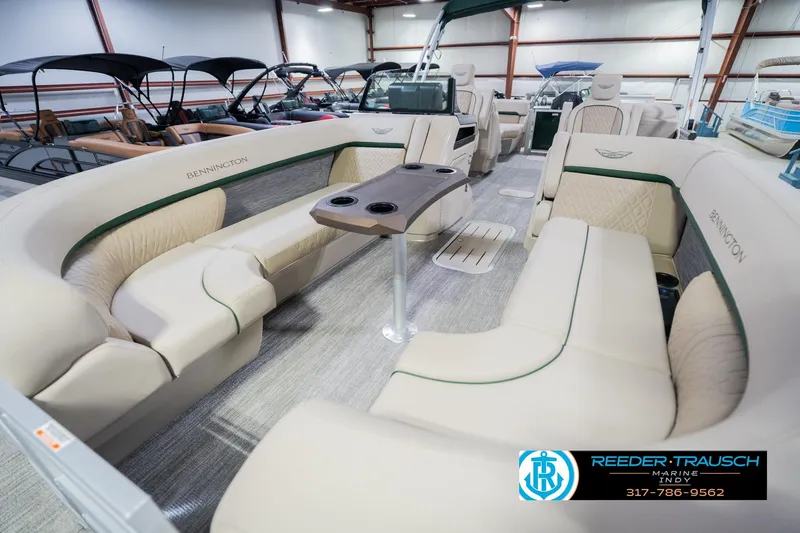 Slide: The Image of 2026 Bennington 24 MFB pontoon boat interior with luxurious seating and table setup. - 11