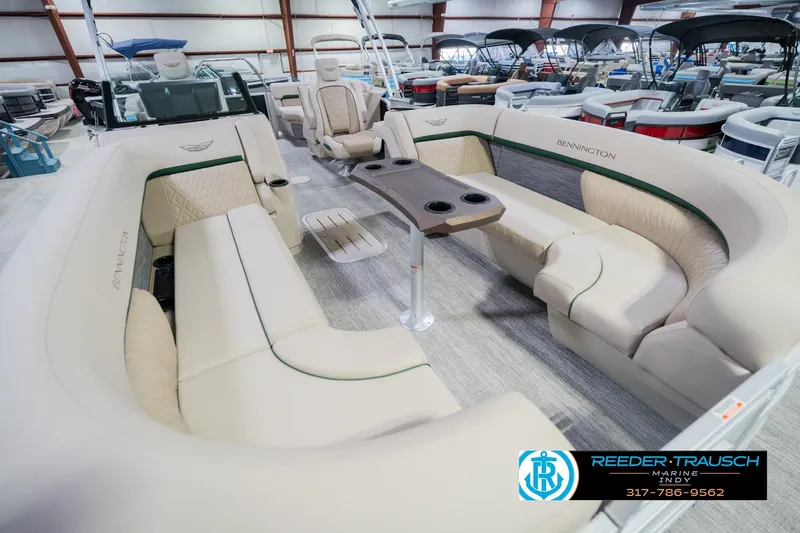 Slide: The Image of 2026 Bennington 24 MFB pontoon boat with luxurious seating in a showroom. - 12