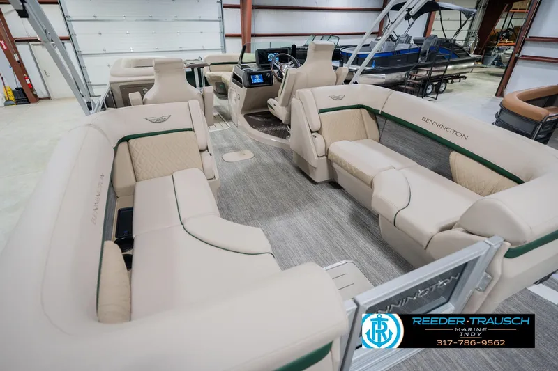 Slide: The Image of 2026 Bennington 24 MFB pontoon boat interior with luxurious seating in a showroom. - 14