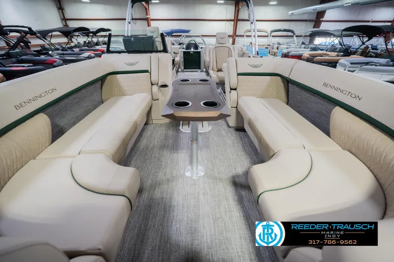 Slide: The Image of 2026 Bennington 24 MFB pontoon boat interior with beige seating and central table. - 15