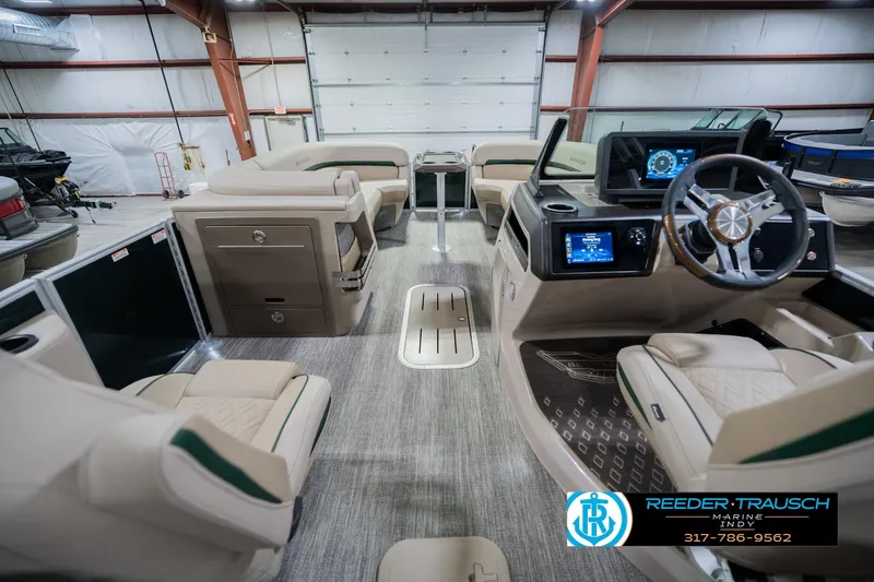 Slide: The Image of 2026 Bennington 24 MFB boat interior with modern dashboard and luxurious seating. - 19