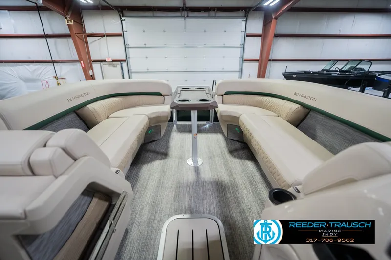 Slide: The Image of Luxurious interior of 2026 Bennington 24 MFB pontoon boat in a showroom setting. - 20
